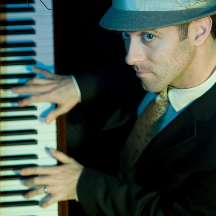 Downward angle of Stevie Einerson playing the piano