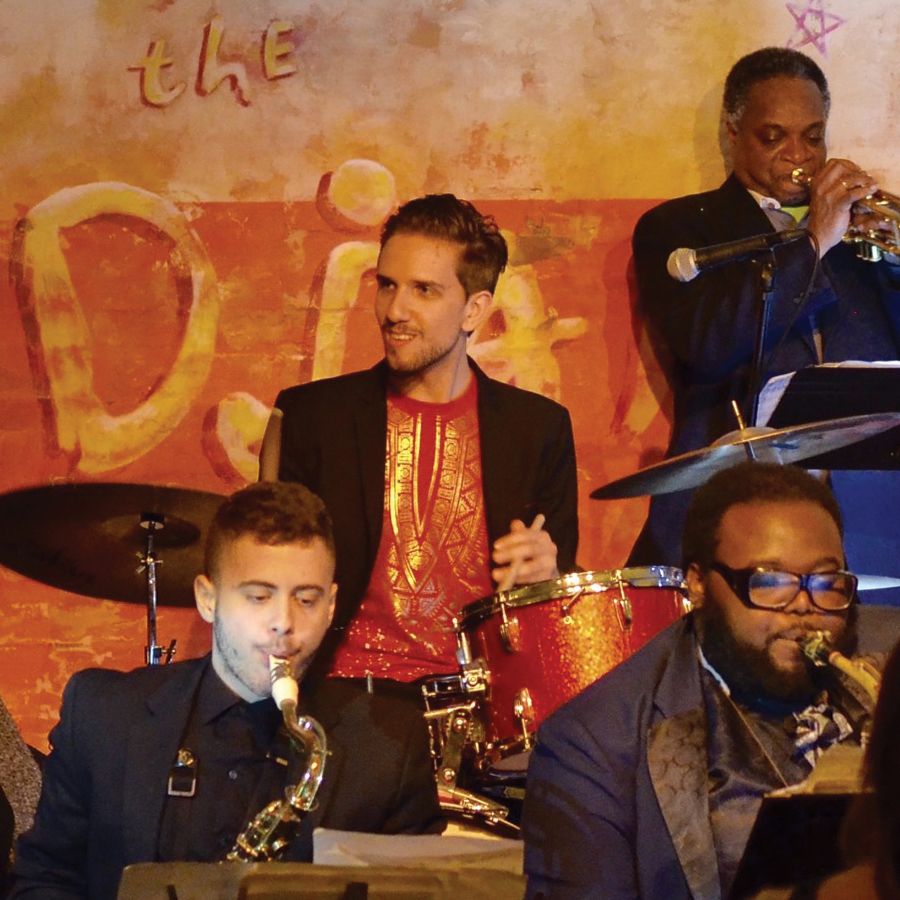 Image of Evan Sherman playing the drums with other artists