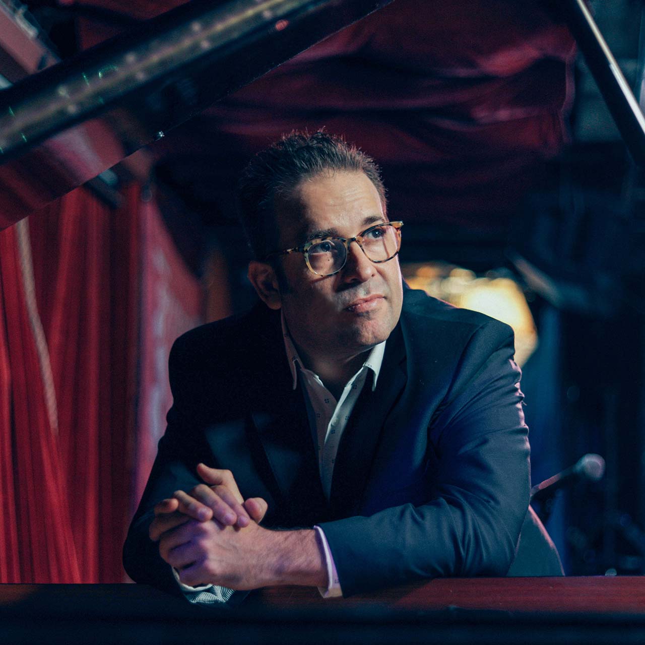 a headshot of a pianist Manuel Valera for his live performance at the django