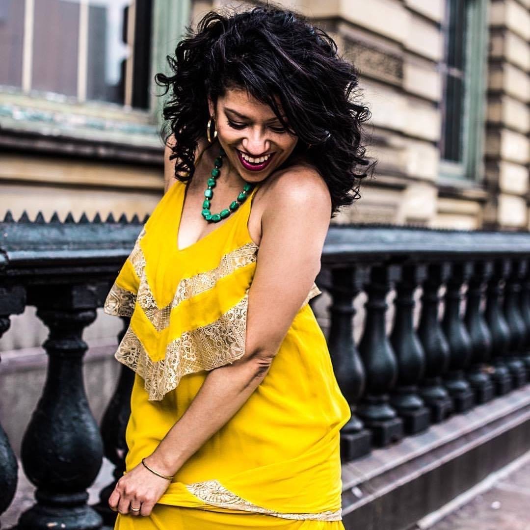 Photo of Marielle Price smiling in a yellow dress