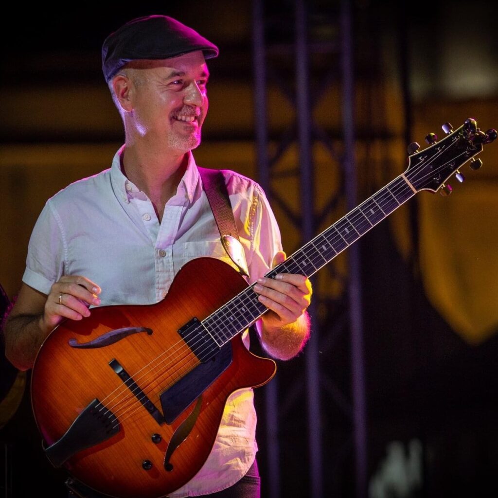 Guitarist Rale Micic performing on stage.