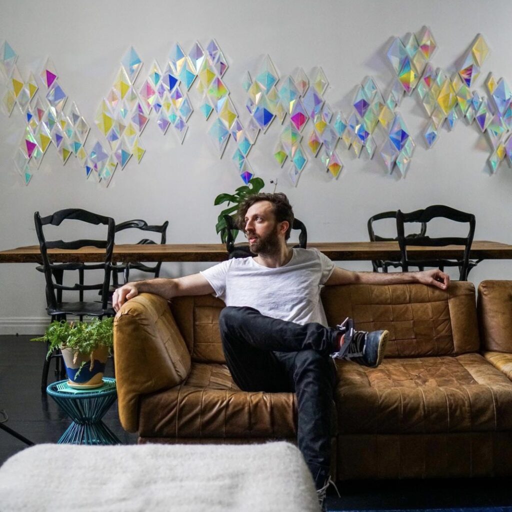 Sean March lounging on a couch