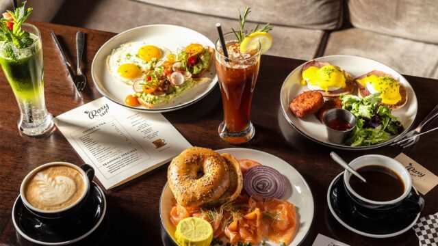 Assortment of breakfast entrees, coffee beverage and iced drinks on the table at Roxy Café in Tribeca.