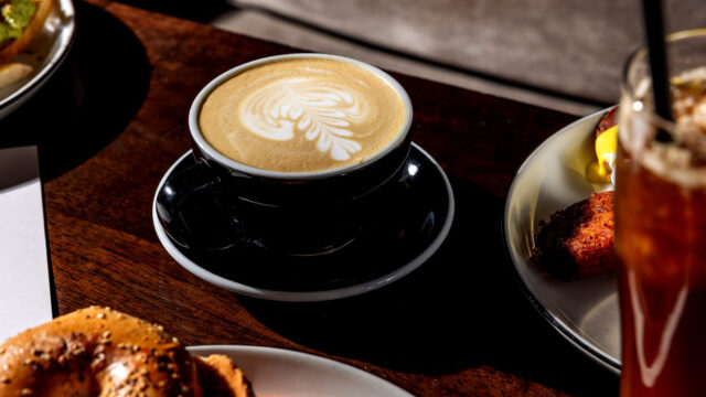 Latte in a black mug at Roxy Café in Tribeca.