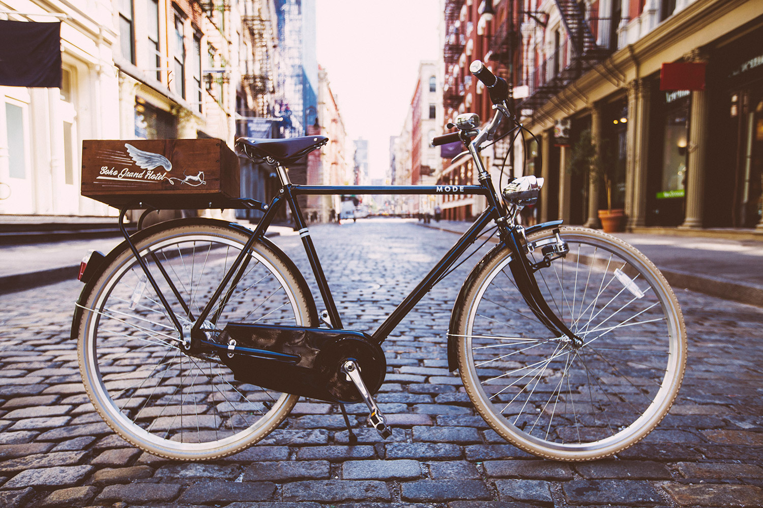 A Soho Grand branded bike is posed on a cobblestone SoHo street