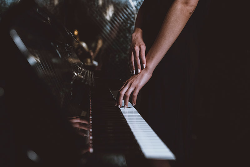 image a a woman's hands playing the piano