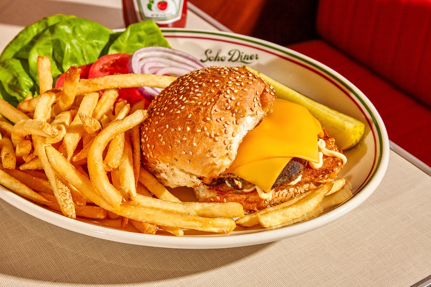Cheeseburger on a plate with French Fries.