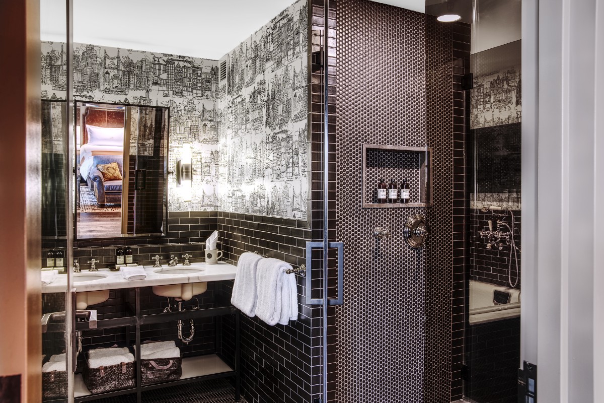 Bathroom Picture of Grand Terrace Suite showing black tile design, shower, vanity and sink.
