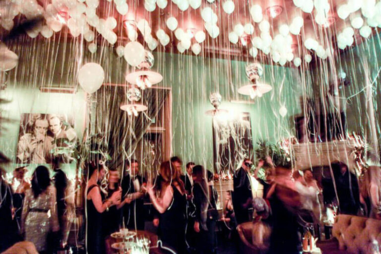 an action shot of a masquerade party taking place at the Soho Grand's Club Room on New Year's Eve