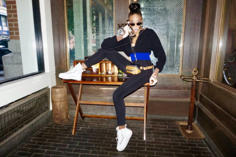 Winnie Harlow sits on a bench at the Soho Grand