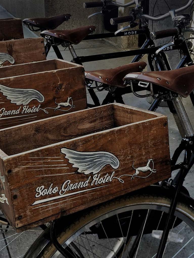 soho grand hotel bikes with wooden boxes with the hotel logo on them
