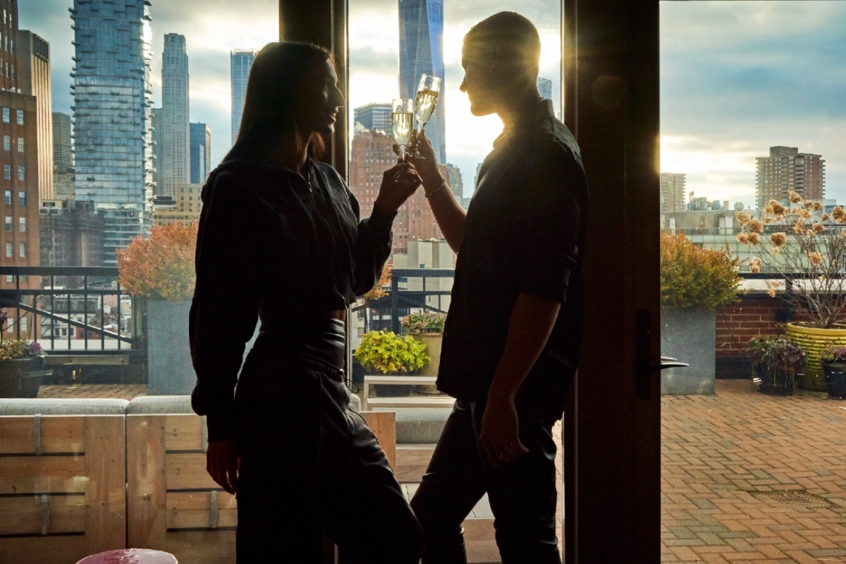 Couple toasting champagne in the penthouse at Soho Grand Hotel.