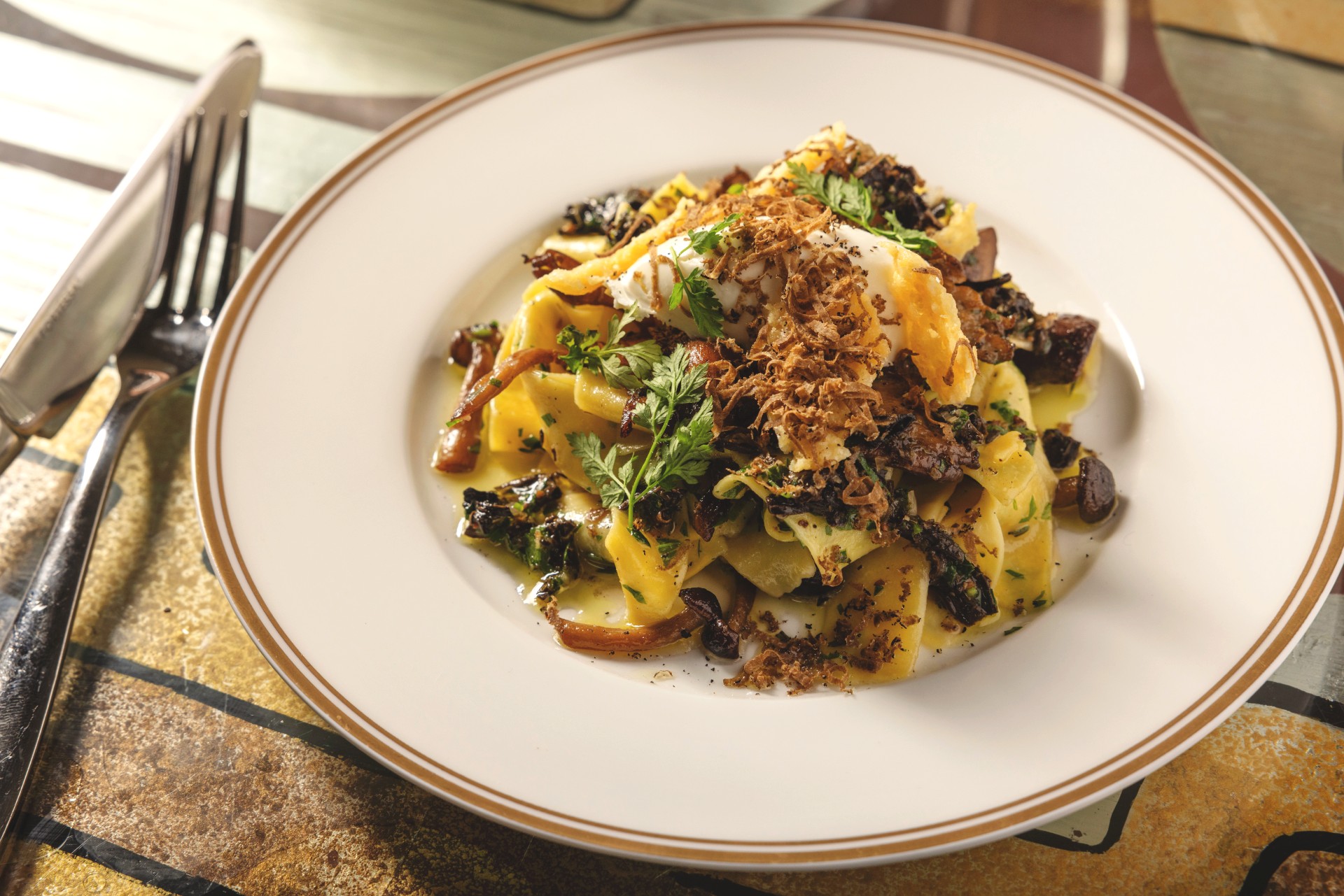 Field Mushroom Pappardelle plated entree on a table at Soho Grand Hotel.