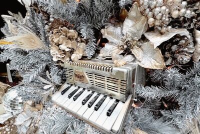 Closeup of Soho Grand Hotel's Silver Christmas Tree with decorations including a small electric piano.