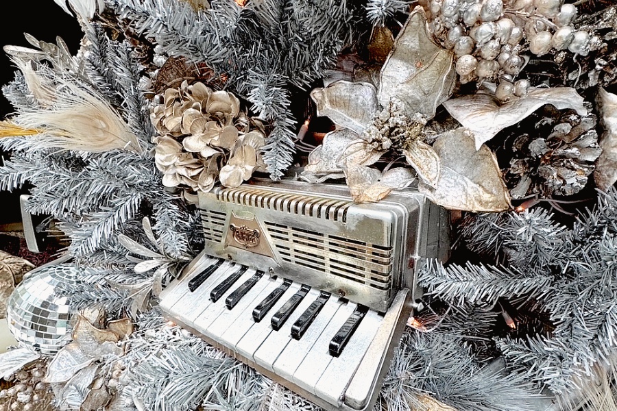 Closeup of Soho Grand Hotel's Silver Christmas Tree with decorations including a small electric piano.