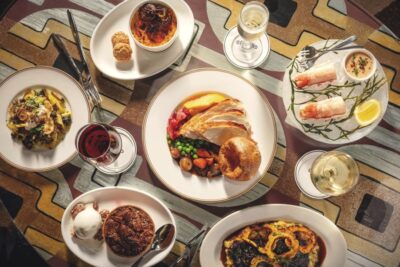 Thanksgiving entrees, side dishes, and desserts on a table at Soho Grand Hotel.