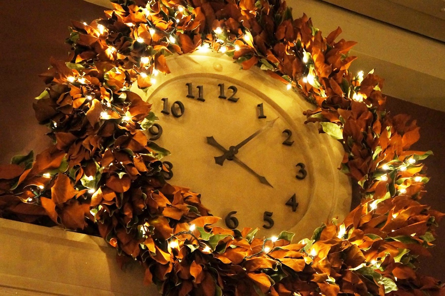 Lobby Wall Clock at Soho Grand Hotel decorated with garland and lights.