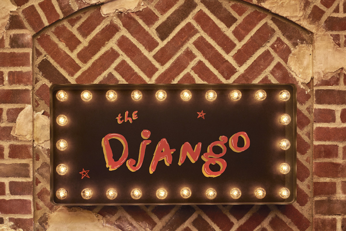 The Django sign. it has bulb lights lining the rim with the logo in the center