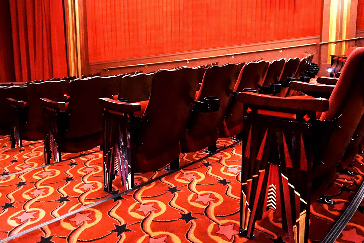 detail shot of the red and yellow patterned carpet and red seats in the roxy cinema
