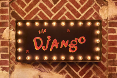 the django sign. it has bulb lights lining the rim with the logo in the center