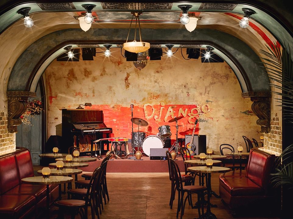The Django main stage with all its instruments including a piano, a drum set and a guitar. There are candlelit tables lining the room