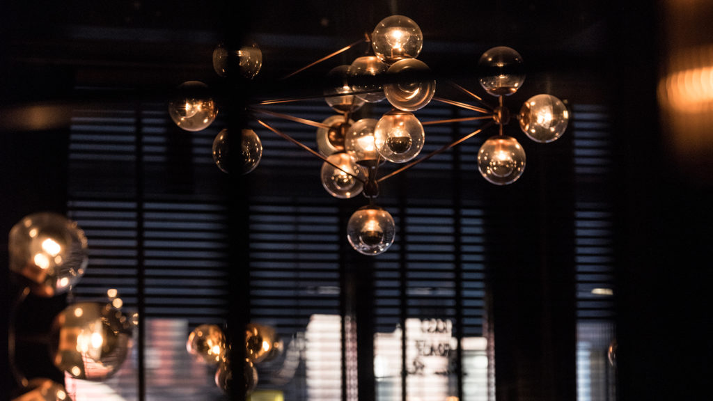 a detail shot of an industrial-style chandelier at the Roxy Hotel's oyster bar