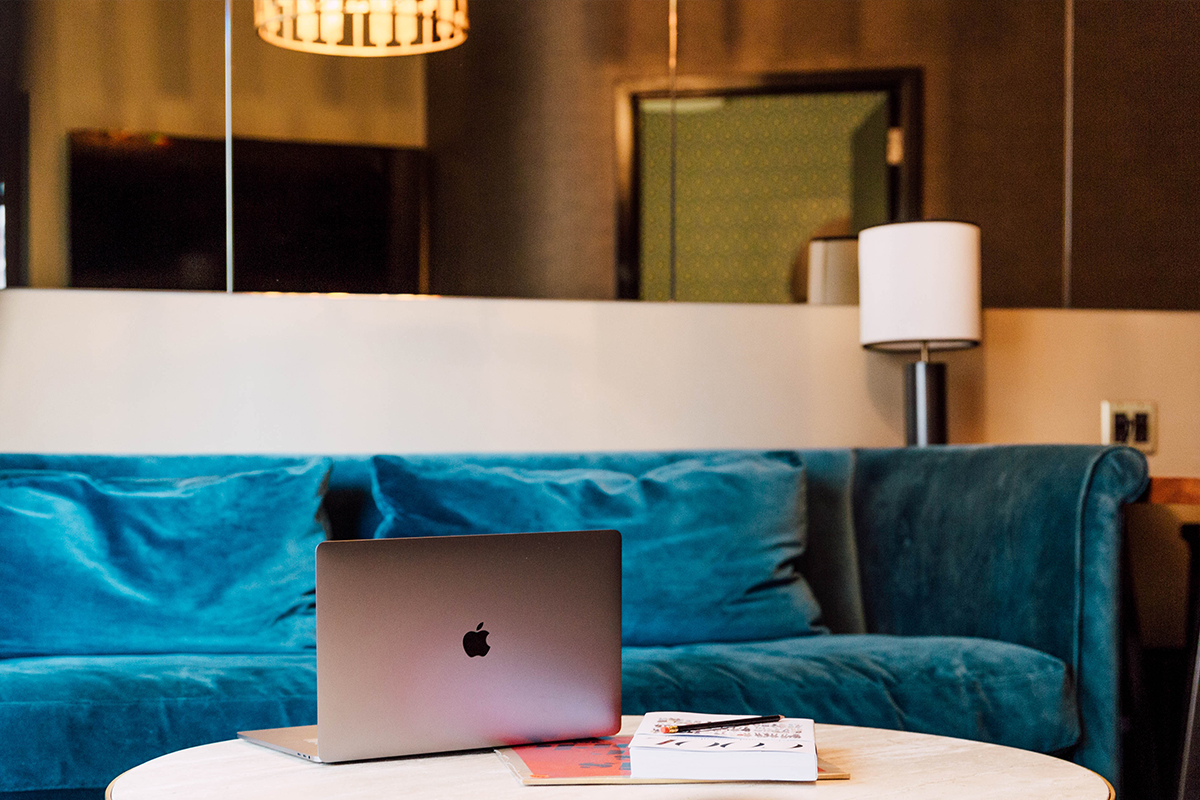 a laptop sits open on the table of a Roxy Hotel suite showing the high-speed wifi amenity the hotel offers