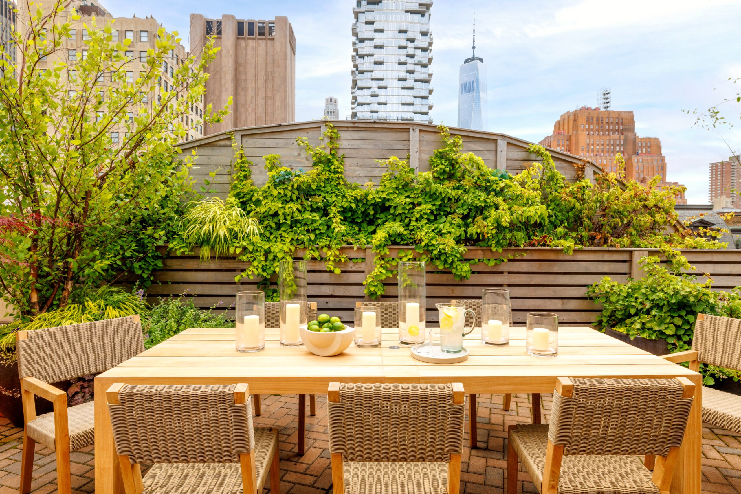 Outdoor Dining Table and Chairs at The Roxy Penthouse Terrace with view of One World Trade Center.