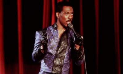 Comedian Eddie Murphy on stage with a microphone.