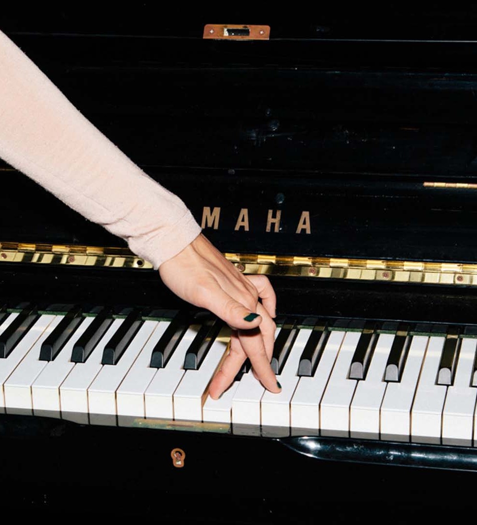 Fingers walking across the keys of a piano