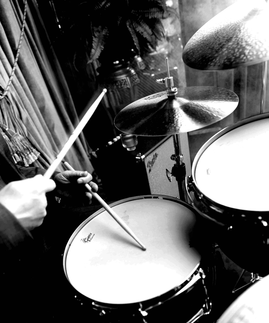Man playing drums at Club Room.