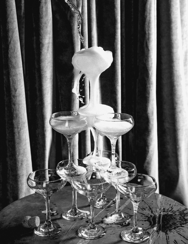 Champagne being poured into a tower of champagne glasses at Club Room.