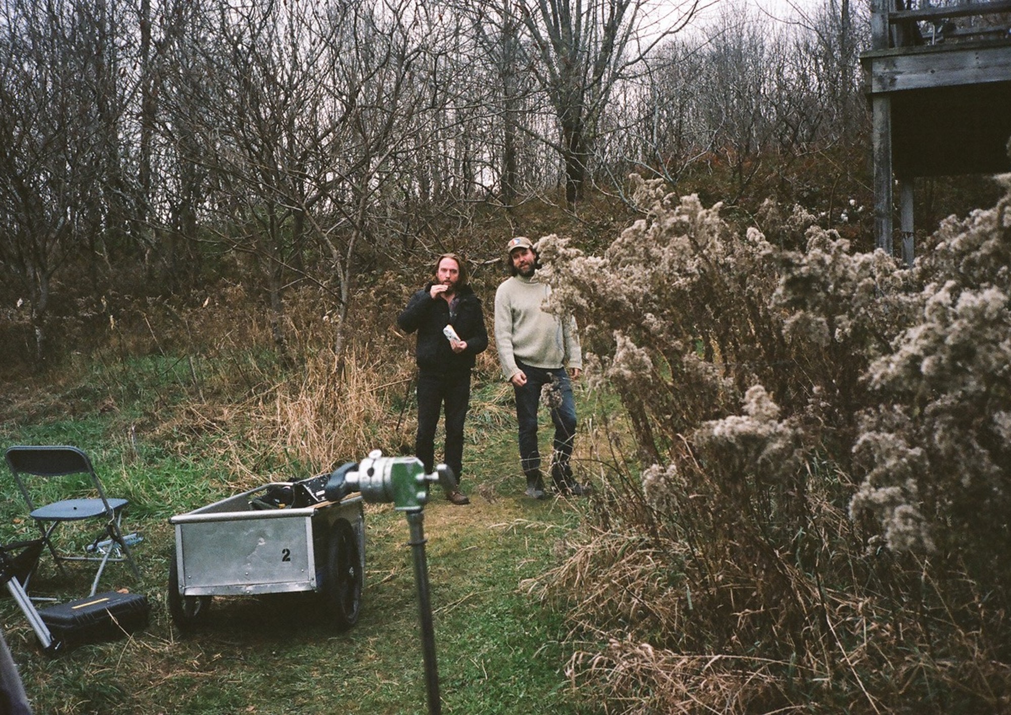 Two men standing in the woods