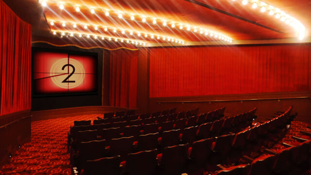 interior of the roxy cinema new york's screening room. the room is classic red with velvet seats