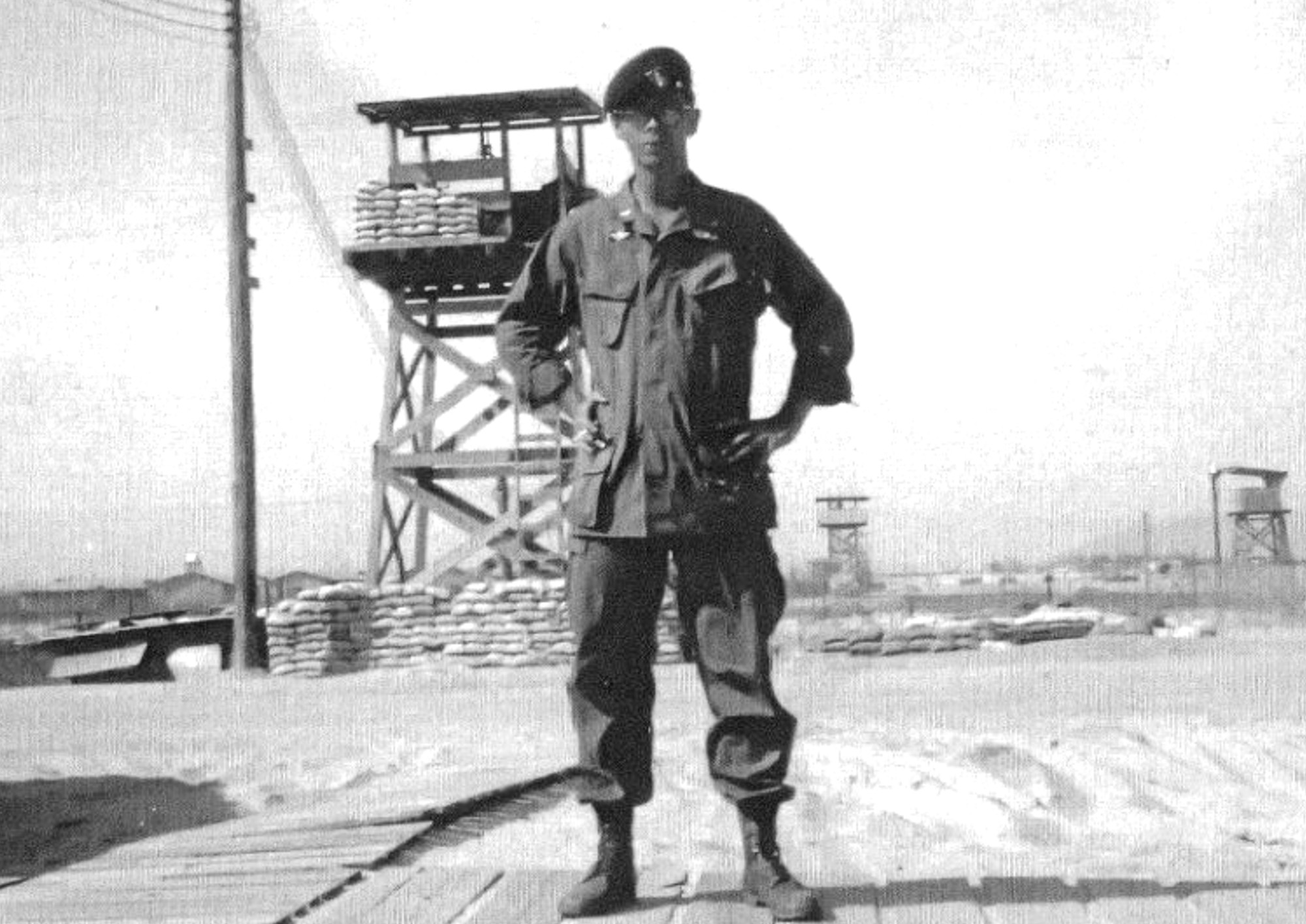 Black and white picture of a green beret on an army base.