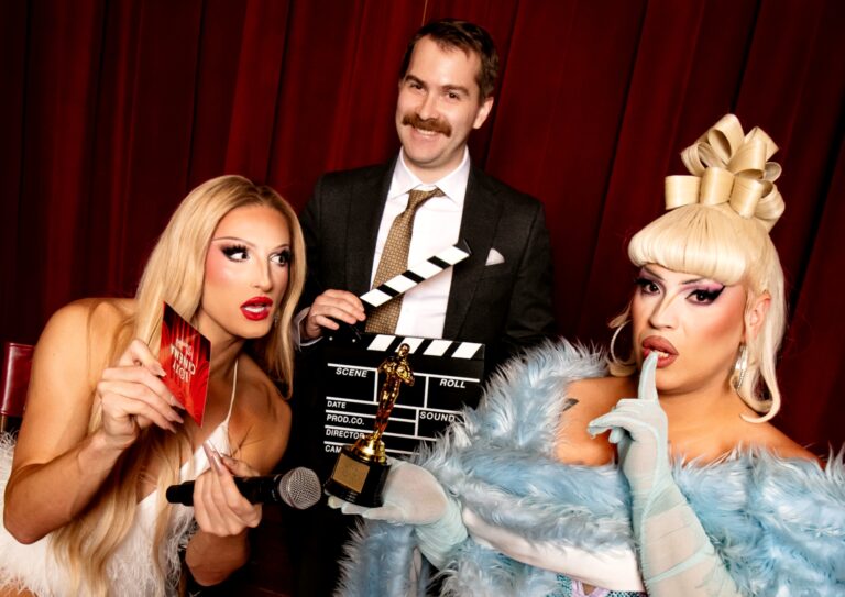 Two drag queens and a man in a suit and tie at Roxy Cinema New York.