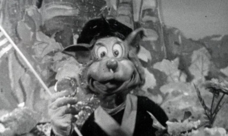 Topsy Turvey film still, puppet holding American Flag