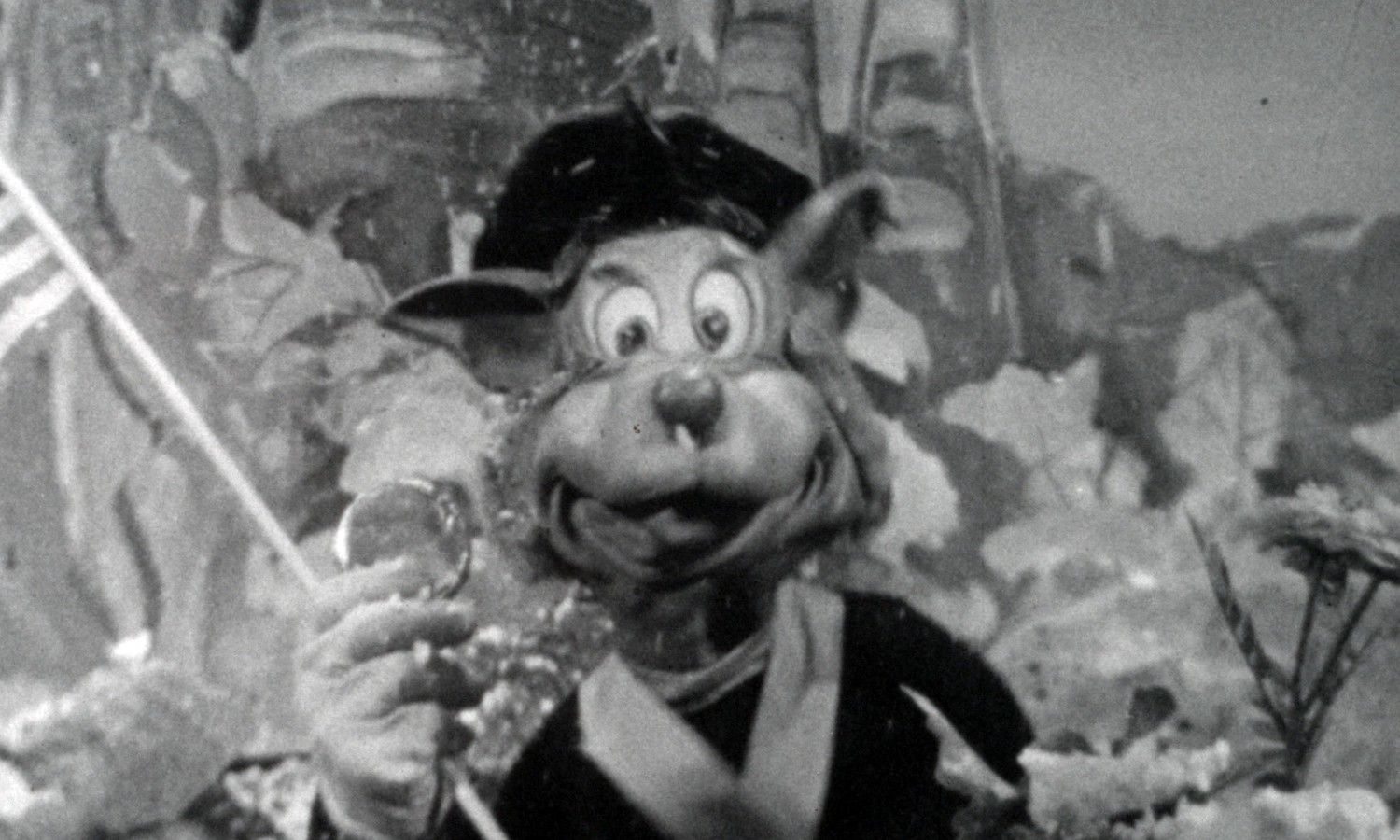 Topsy Turvey film still, puppet holding American Flag